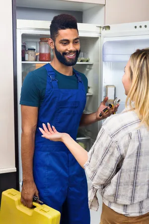 Sparkle-Appliance-Freezer-Repairman-With-Housewife-Repairing-Freezer Sparkle Appliance Freezer Repairman With Housewife Repairing Freezer