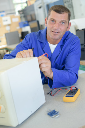 Sparkle Appliance Microwave Repairman Repairing Microwave