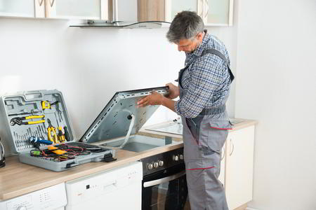 Sparkle Appliance Repairman Working On Springfield Electric Stove Repair