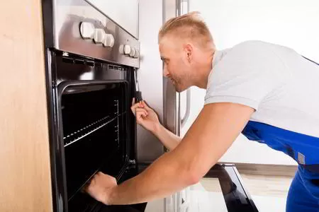 Sparkle Appliance Repairman Working On San Francisco Oven Repair In Kitchen