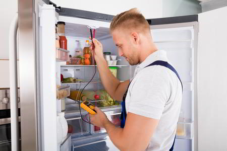 Sparkle Appliance Repairman Working On Refrigerator Repair Decatur With Digital Multimeter