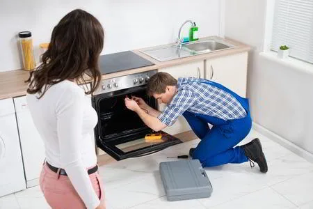 Sparkle Appliance Technician Fixing Gas Stove Igniter In Kitchen