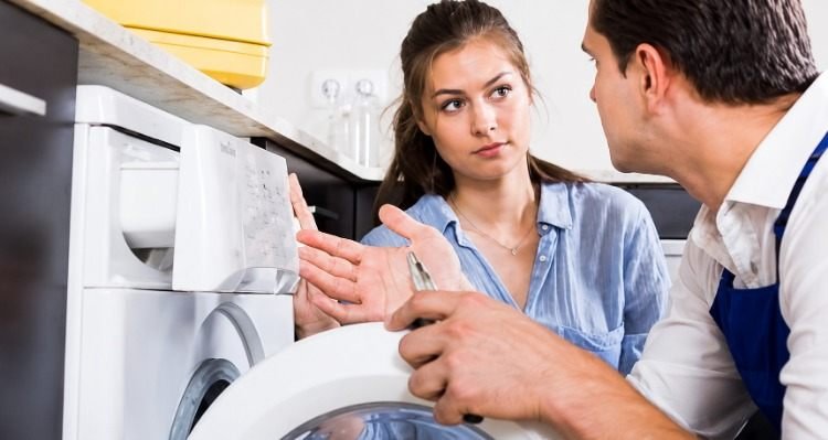 Sparkle Appliance Technician With Housewife Repairing Washing Machine