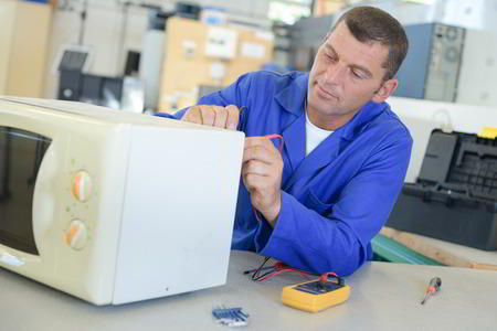 Sparkle Appliance Technician Working On Decatur Microwave Repair
